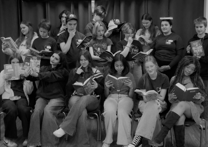 Teen member of TAG reading books